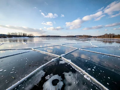 Open water reflecting sky between ice