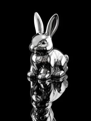 A chocolate bunny with a mirror-chrome coating, the reflective surface catching 