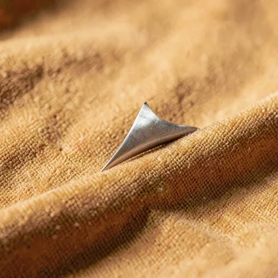 Product of a single fin in profile on a stretch of warm canvas