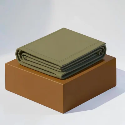 Catalog hero of a folded yoga blanket on a deep ochre block, even directional li