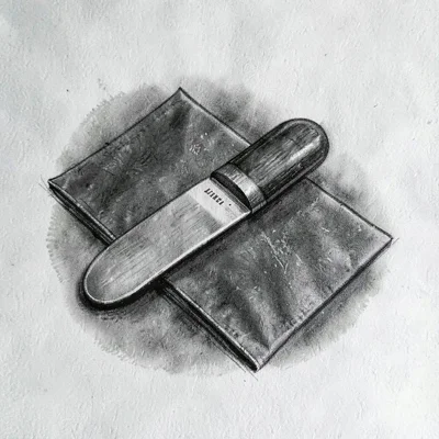 Charcoal study of a bone folder resting on a sharp valley fold, tonal halo softe