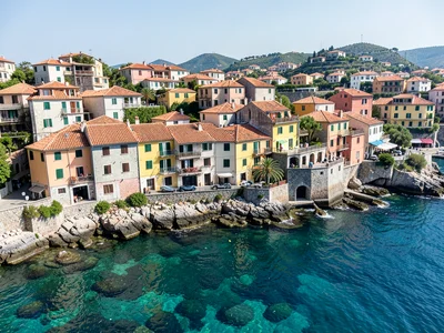 Terracotta rooftops above, Mediterranean seabed below, split-level coastal villa