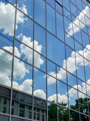 Glass facade reflecting sky