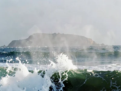 Distant headland through spray haze