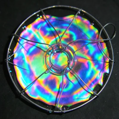 Soap film in wire frame, psychedelic interference patterns, iridescent surface t