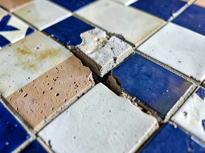 Chipped tile revealing layers beneath current surface