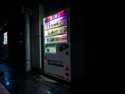 Japanese vending machine lighting street corner, hot coffee selection, the solo 