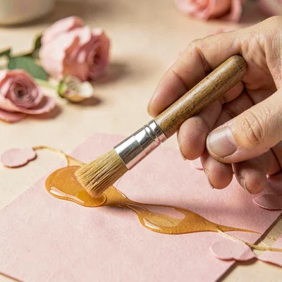 Papercraft hero of a layered paper-cut artist hand picking a paper-cut brush, wa