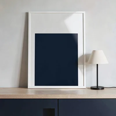 Bold blockcolor og card of a mirror over a console with a small lamp in flat pla