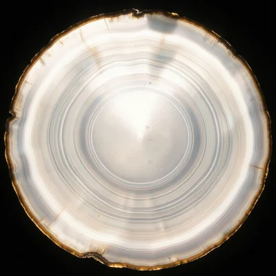 Cross-section of agate stone, concentric bands, backlit showing translucent laye