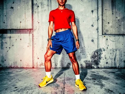 Sportswear editorial in primary colours — red top, blue shorts, yellow sneakers 