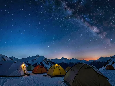 High camp tents under sky transitioning from evening blue to cosmic black