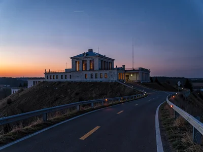 Observatory access road ascending toward twilight