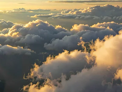 Evening light catching only the highest cloud edges in gold