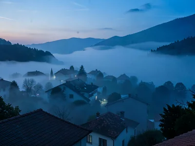 Village emerging from fog with only rooftops visible
