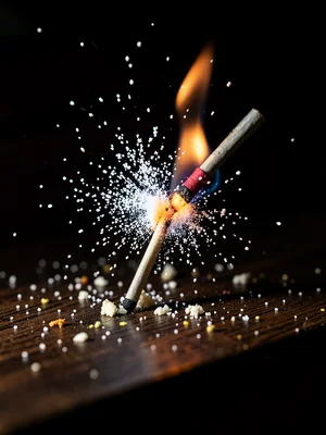 Match head at moment of ignition with phosphorus particles frozen in bloom