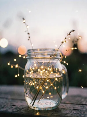 Fireflies in a mason jar at twilight