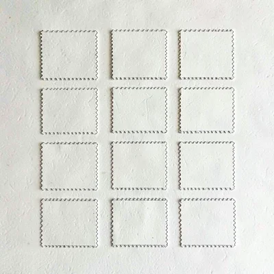 Modular grid of twelve postage stamp corners on cream card, faint paper grain
