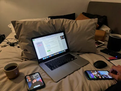 Laptop in bed with pillow barrier, work document and Netflix competing