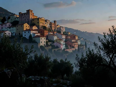 Evening-blue hill town across the valley, last warm light only on the highest wa