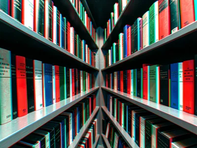 A bookshelf receding at an angle with book spines at different depths showing pr
