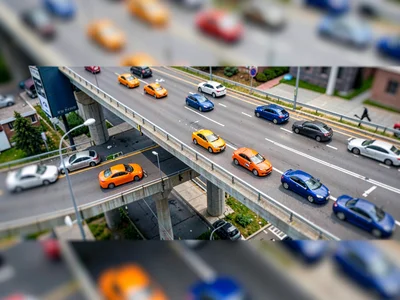 Elevated highway tilt-shift photograph from a billboard catwalk, saturated tange