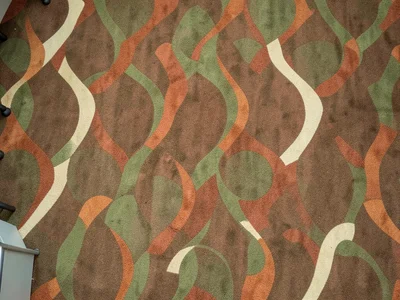 A mid-century modern hotel lobby, carpet with an atomic-age pattern of boomerang