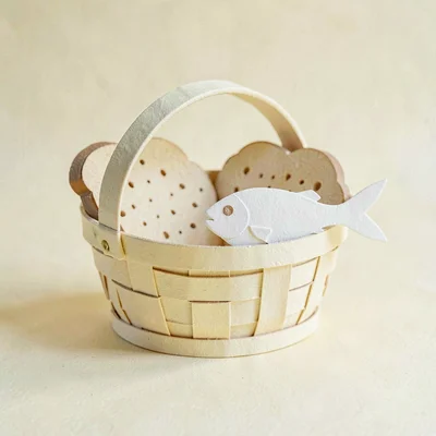 Papercraft ig-tile of a paper-cut basket with paper-cut bread and a paper-cut fi