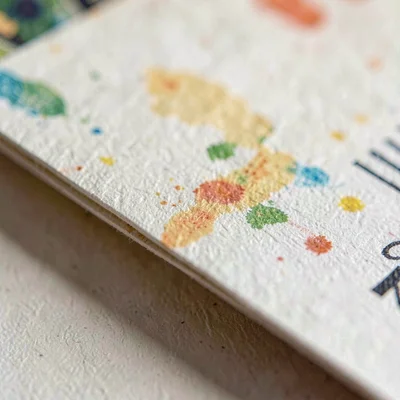 Macro of paper grain along a folded program edge with faded pigment