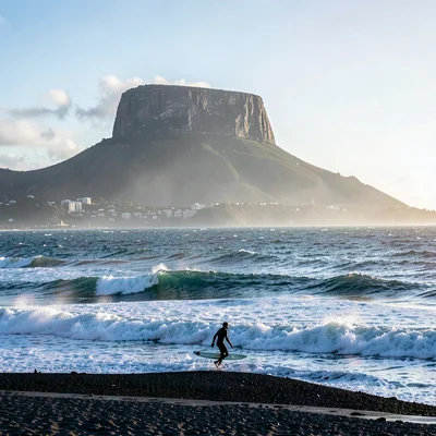 Cape Town mountain-sea duality, Table Mountain backdrop, surfer silhouette walki