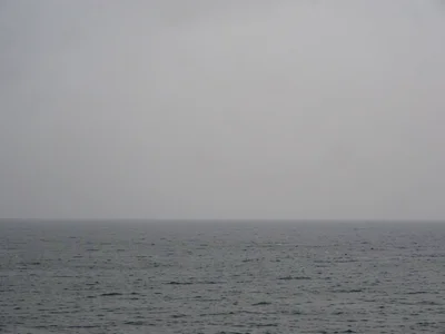 Horizon line only, grey sky meeting grey sea, the negotiation between elements
