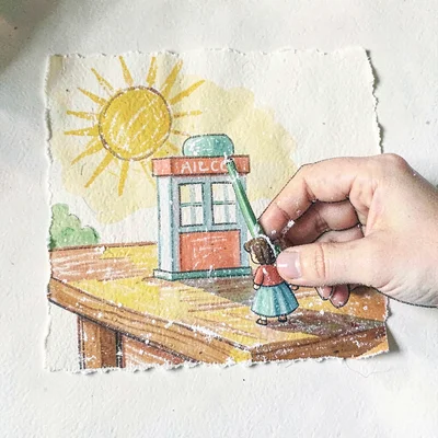 Small hand placing a tiny figure beside the station on a sunlit table