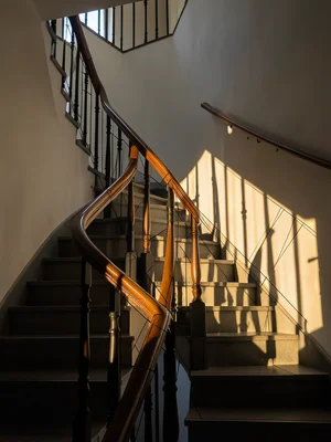Staircase photo where handrail and balustrade become technical drawing mid-struc
