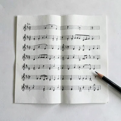 Paolo-paperfold layout of a single open quartet score with a graphite pencil in 