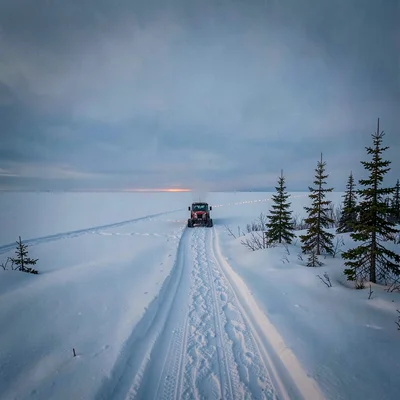 Photograph with Alaskan Arctic sensibility, Snowmachine trail cutting across whi