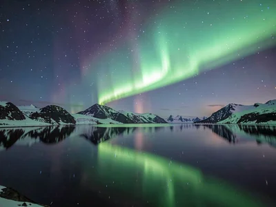 Aurora reflecting in still lake doubling the display