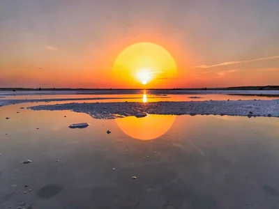Sunset reflecting creating continuous orange sphere