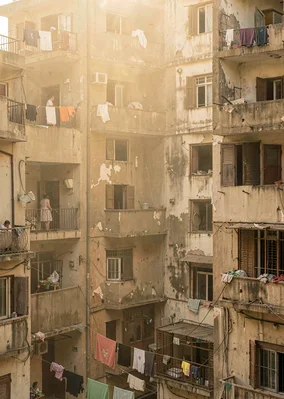 Dusty golden Cairo haze compressing apartment layers, shuttered windows in after