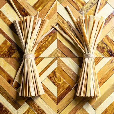 An overhead view of loose split straws before application — bundled in warm gold