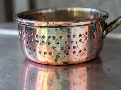 Copper pot showing hammer marks and patina