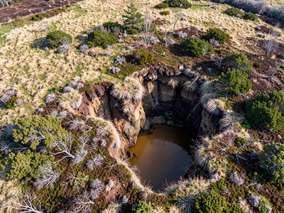 Active peat erosion creating cliff edges visible from above
