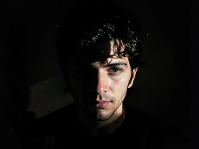 Phone screen illuminating face in dark