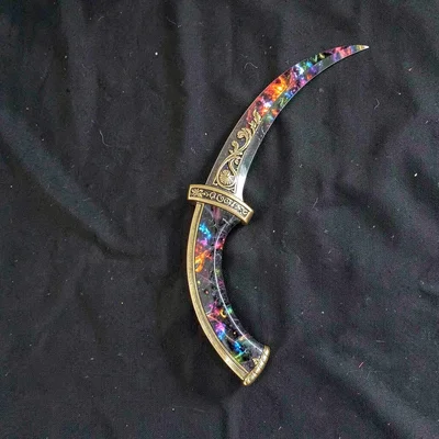 Ornate prop study of a curved cinder blade with brass guard and obsidian edge, i