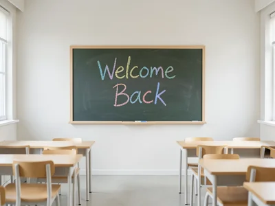 Chalkboard with "Welcome Back" written in colorful chalk, clean classroom