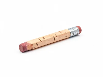 Worn pencil stub two inches long, teeth marks visible, eraser worn to metal, stu