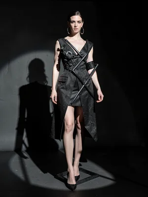 Model in avant-garde sculptural dress, seven lights creating impossible shadow g