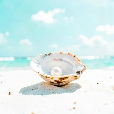 Expansive turquoise negative space, bleached whites, A single pearl in an open o
