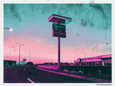 Freeway off-ramp at twilight with a gas station sign rising above a flat horizon