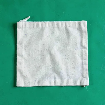 single foldable canvas makeup-kit pouch flattened top-down on a saturated emeral