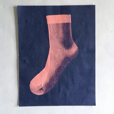 Bold screenprint poster of a halftone single-sock silhouette in coral over flat 
